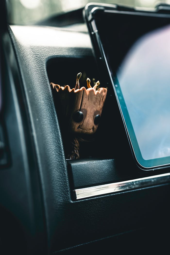 Adorable car accessory styled in the dashboard of a vehicle interior. Perfect for auto enthusiasts.