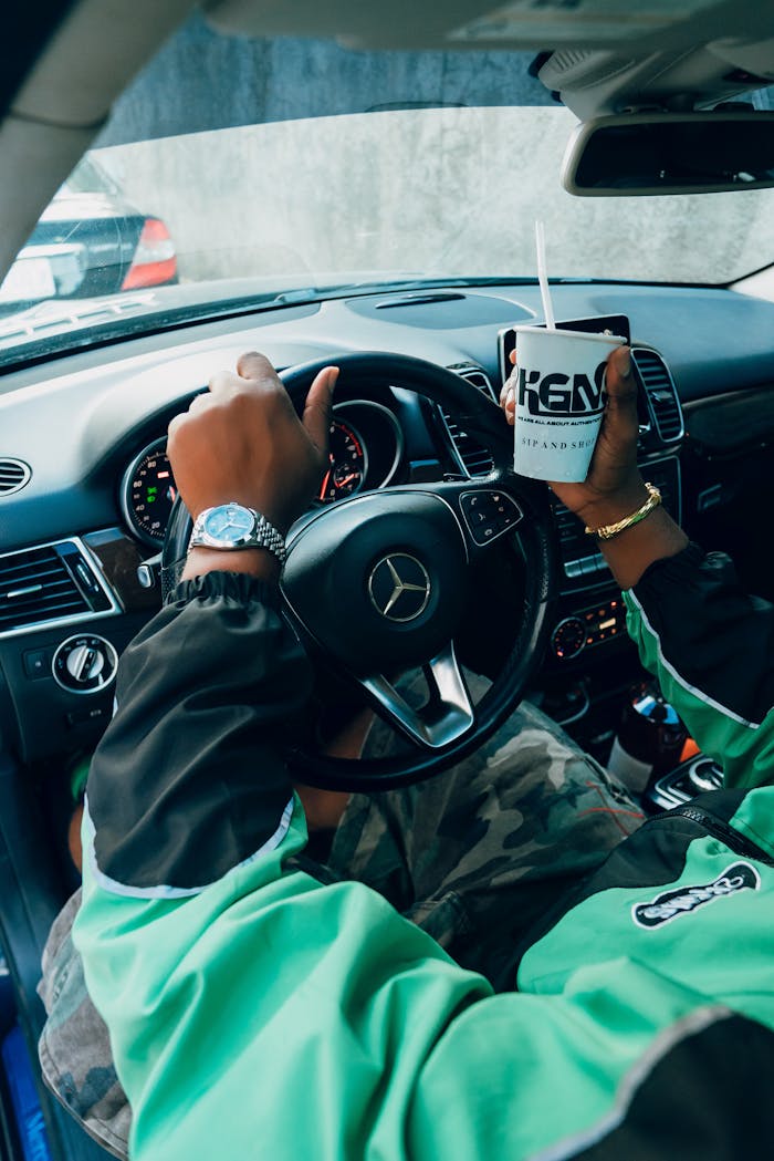View from driver's seat in a luxury car, highlighting modern urban lifestyle.